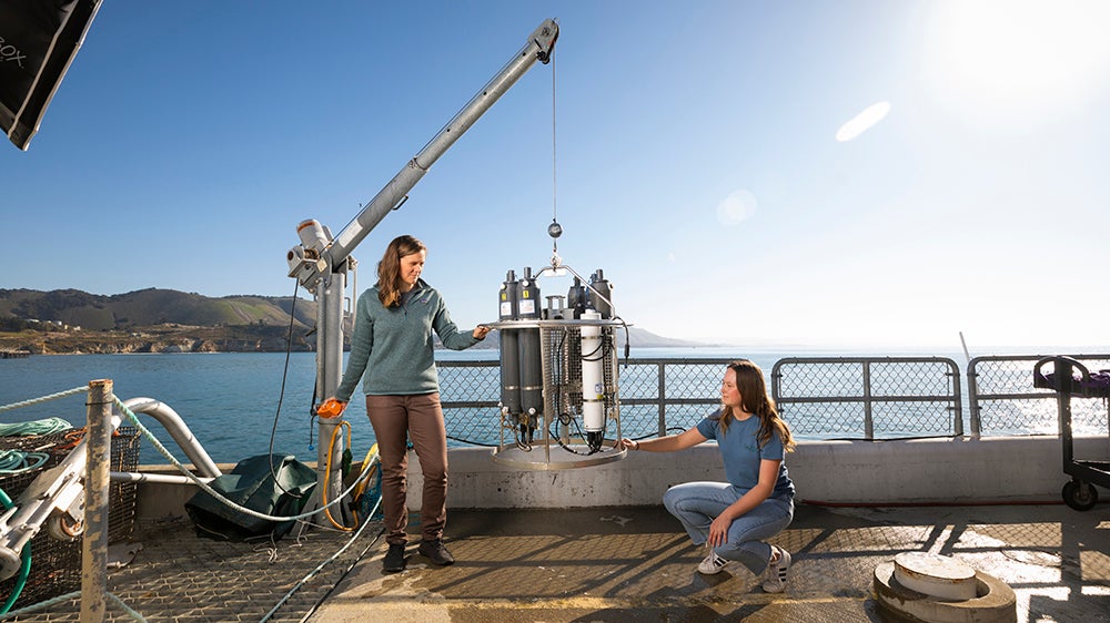 Student and faculty work with equipment at the Cal Poly Pier in Avila Beach