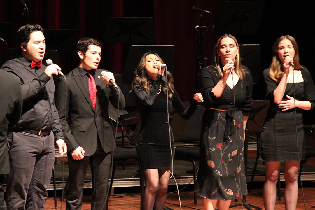 Cal Poly students sing in on stage