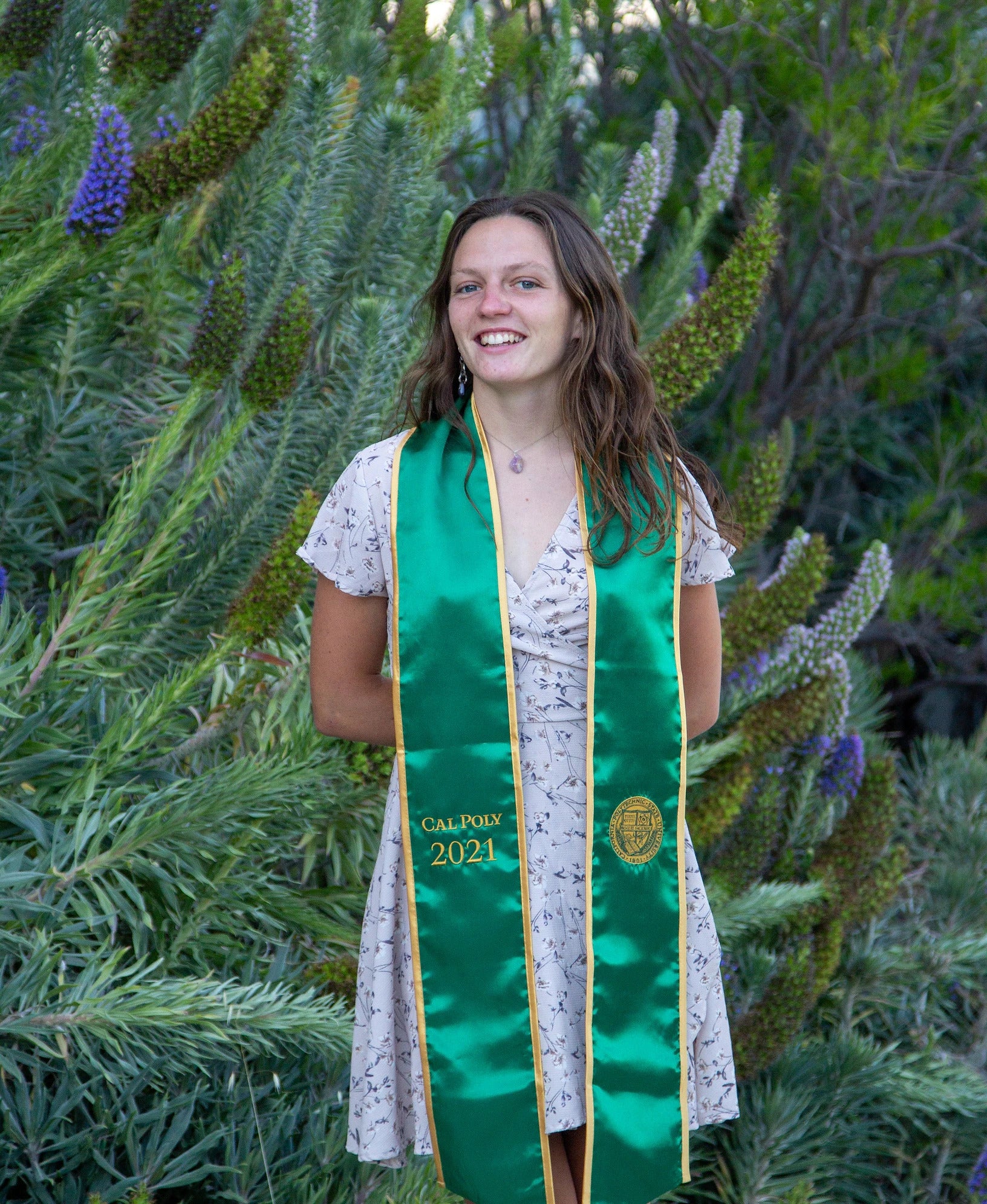 Noel Clark , a 2021 Marine Science alumna, stands cloaked in a College of Science and Math stole