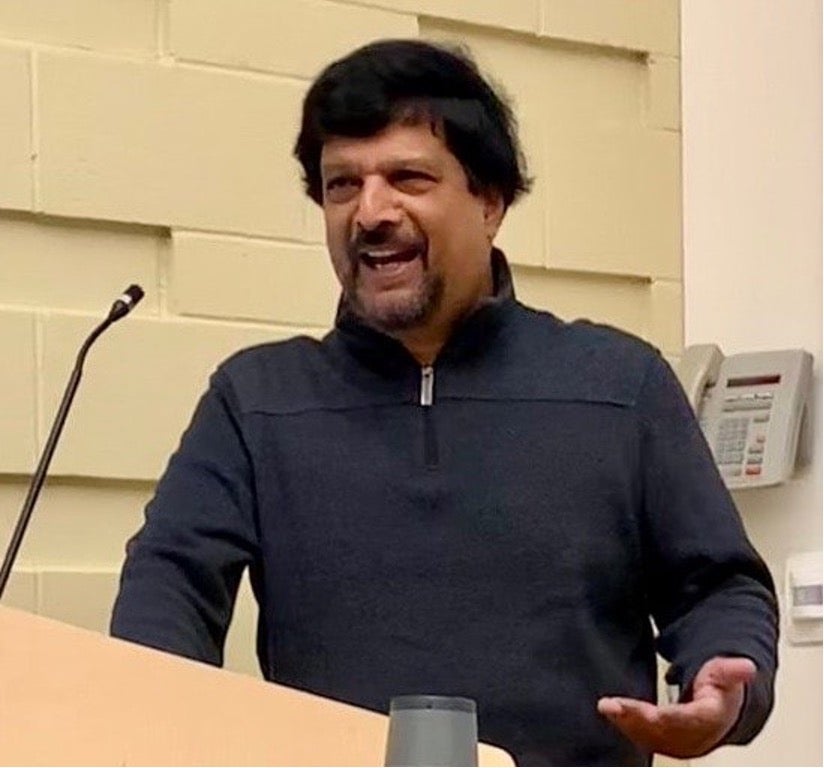 Professor Suresh Canagarajah speaks from a podium