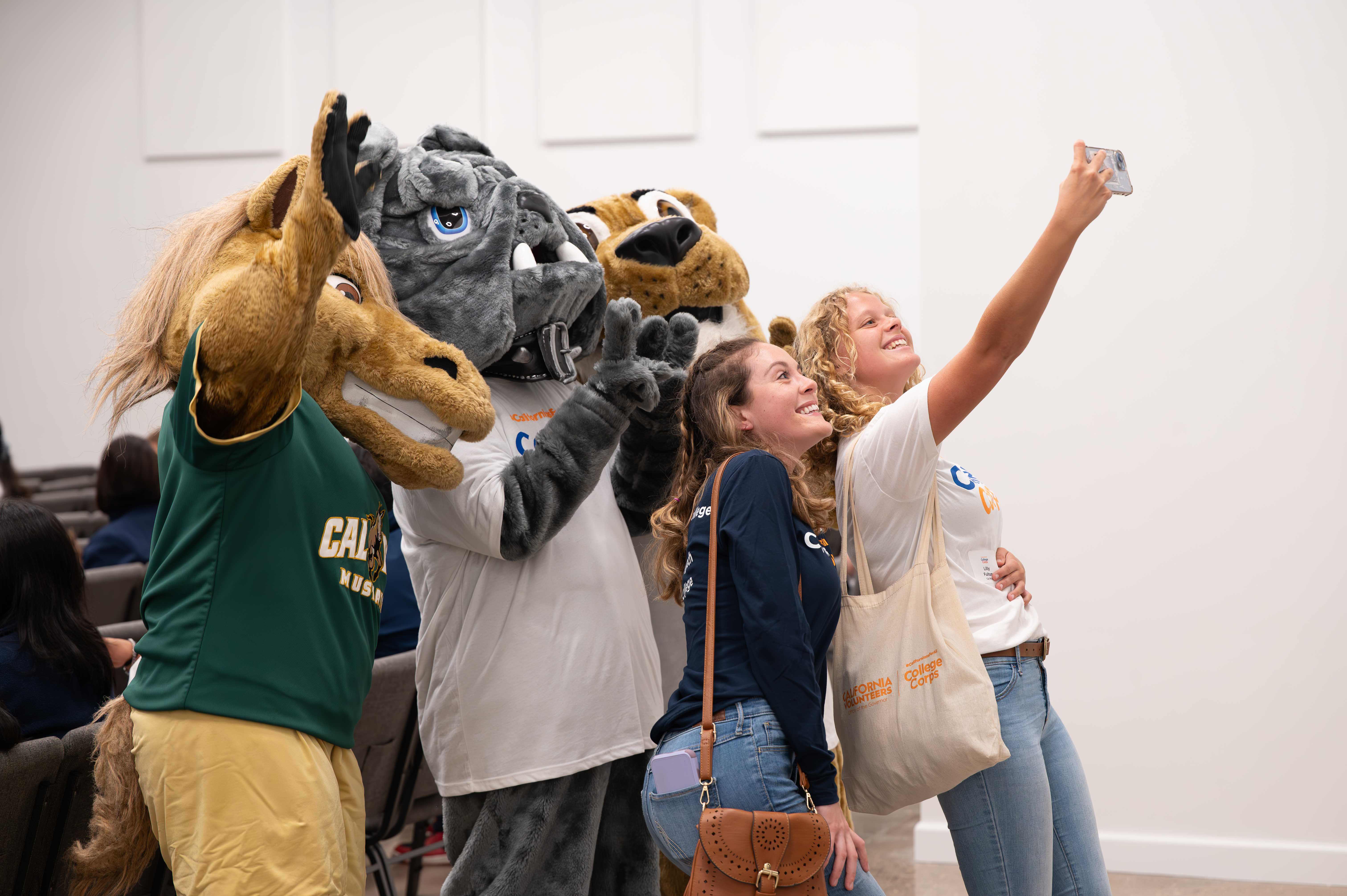 Students take selfie photos with Cal Poly Cuesta and Allan Hancock colleges school mascots