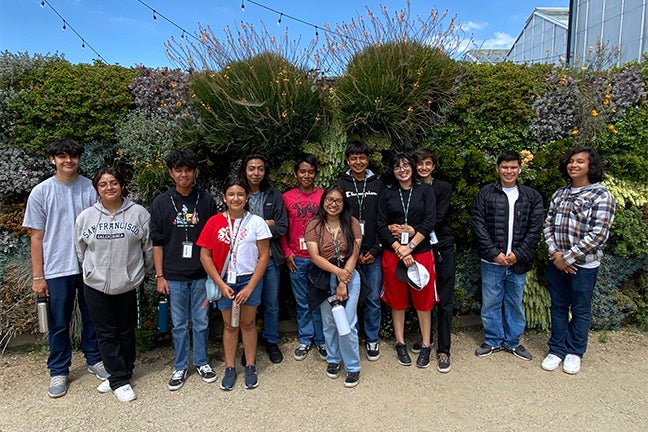 High school students in Cal Poly’s Upward Bound program pose on campus in front of the Plant Conservatory