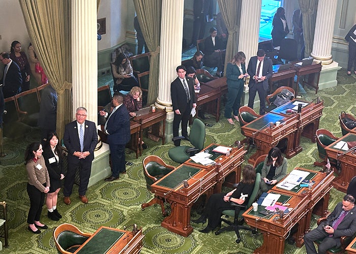 Cal Poly students and President Armstrong on the floor of the state Assembly