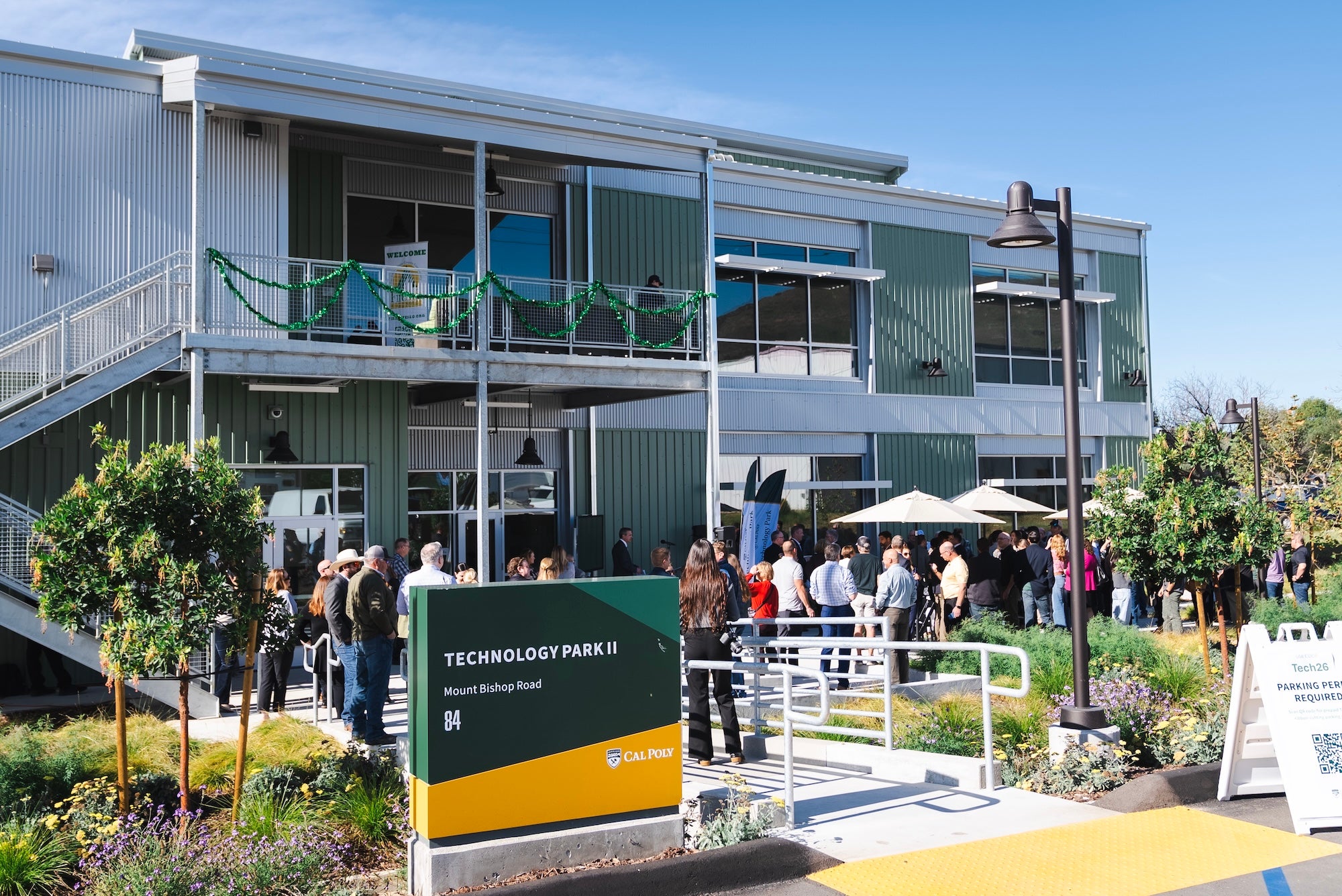 Attendees celebrate at the ribbon cutting for the opening of the second phase of the Tech Park on Mount Bishop Road