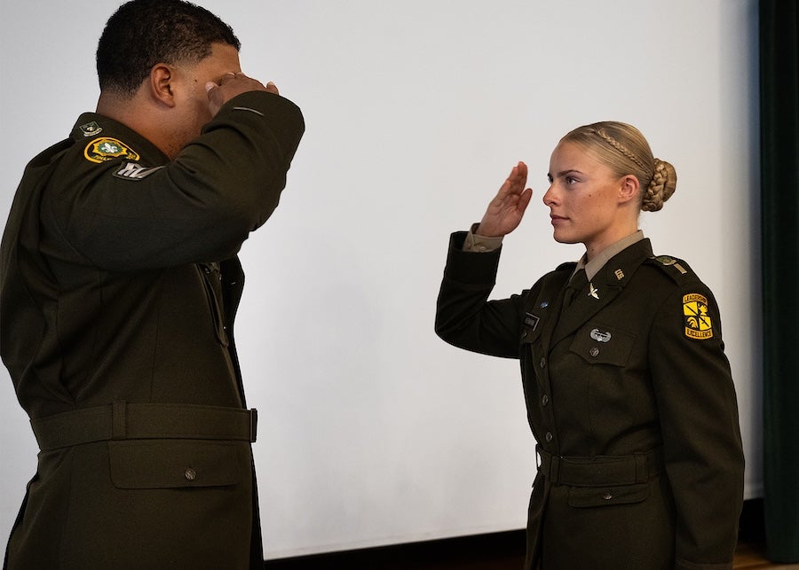 2nd Lt. Isabel Hermann returns her first salute from Sgt. 1st Class Federico Lara
