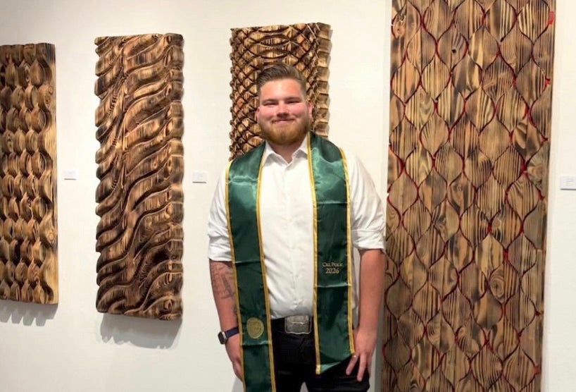 Tilman Stoppler with some of his wood media creations at a student retrospective at Cal Poly