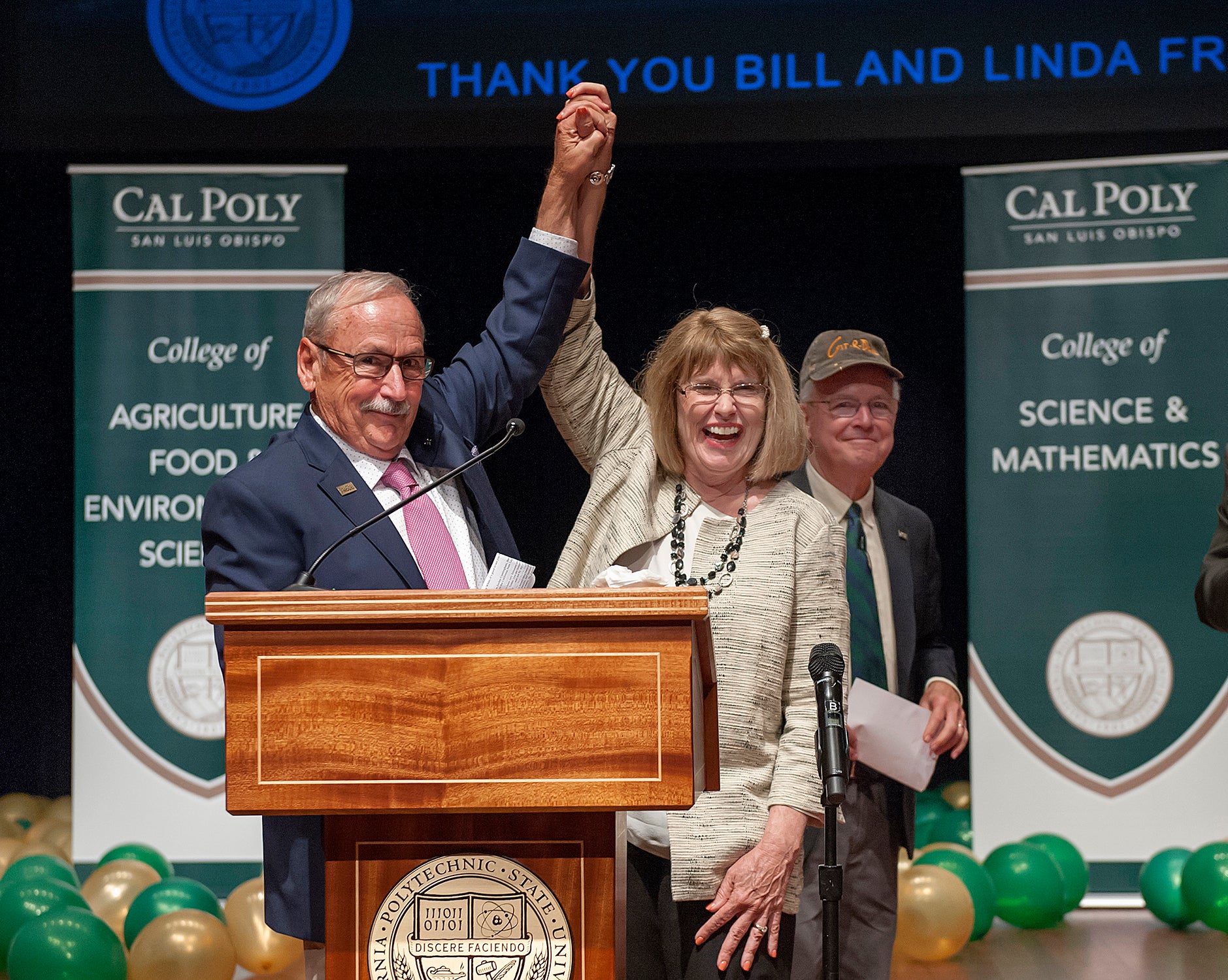 William and Linda Frost raise arms in announcing their transformational donation to Cal Poly in 2017