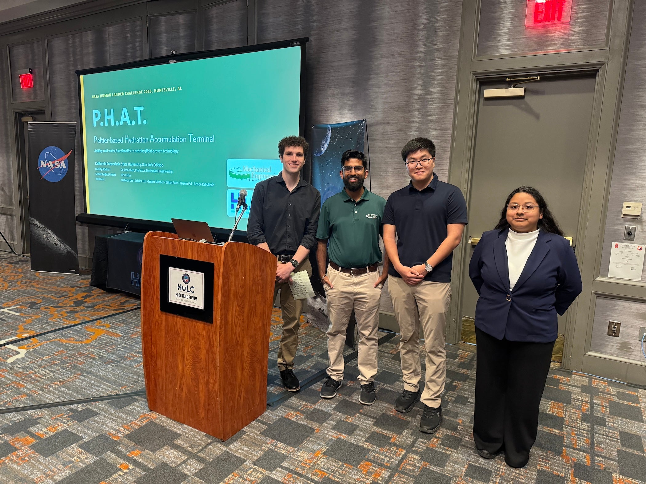 Ethan Pace, Tarsem Pal, Taehoon Lee and Renee Rebolledo stand near the podium after presenting their winning design at NASA’s 2026 Human Lander Challenge in Huntsville, Alabama.