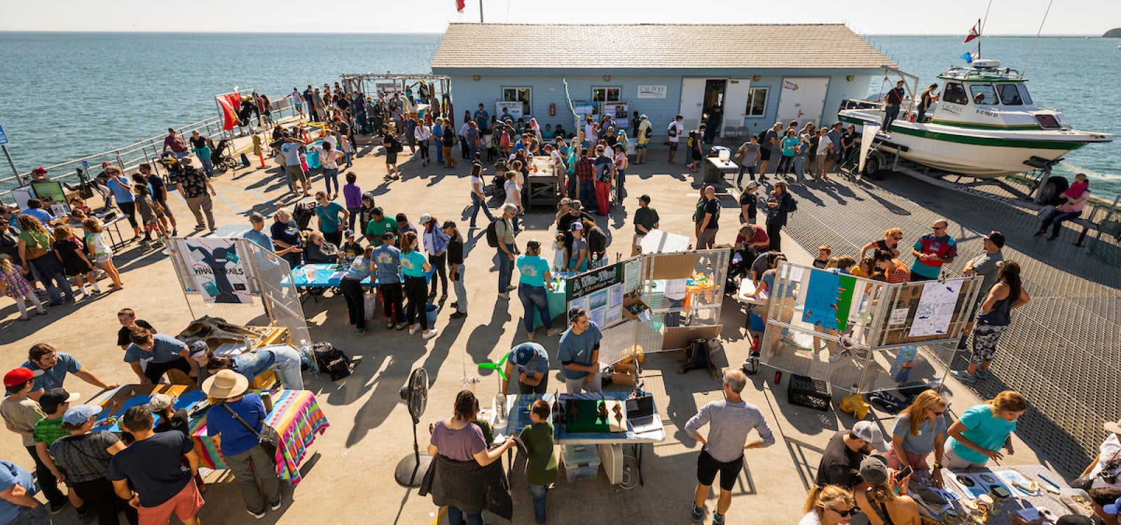 Marine displays set up on the Cal Poly Pier are visited by Open House attendees in 2019