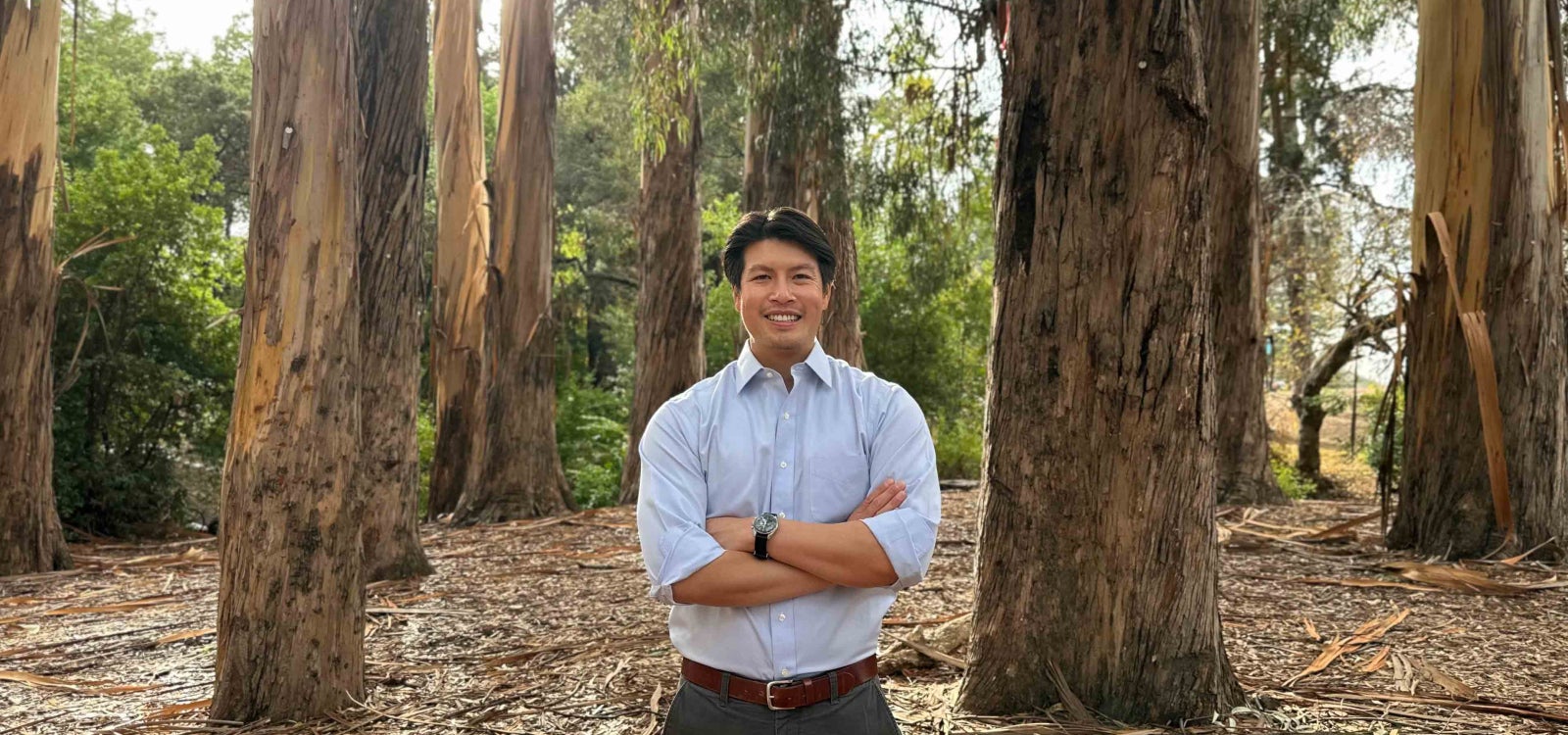 Cal Poly Assistant Professor Jason Poon in a stand of eucalyptus trees