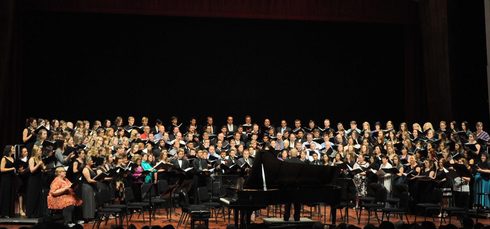 Cal Poly full choir crowds the stage during a performance