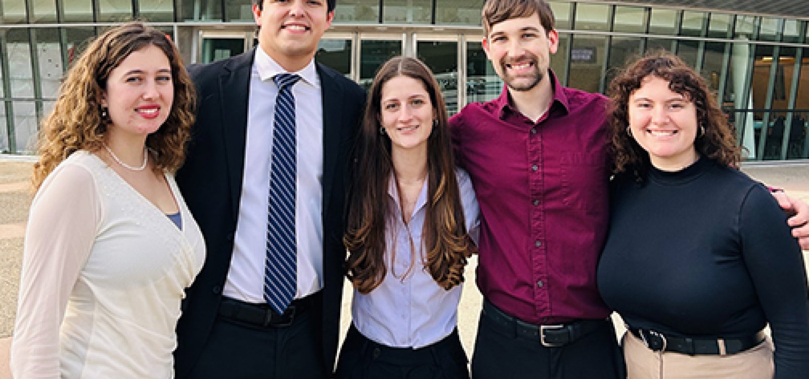 Five Cal Poly music students named soloists stand outside the Performing Arts Center