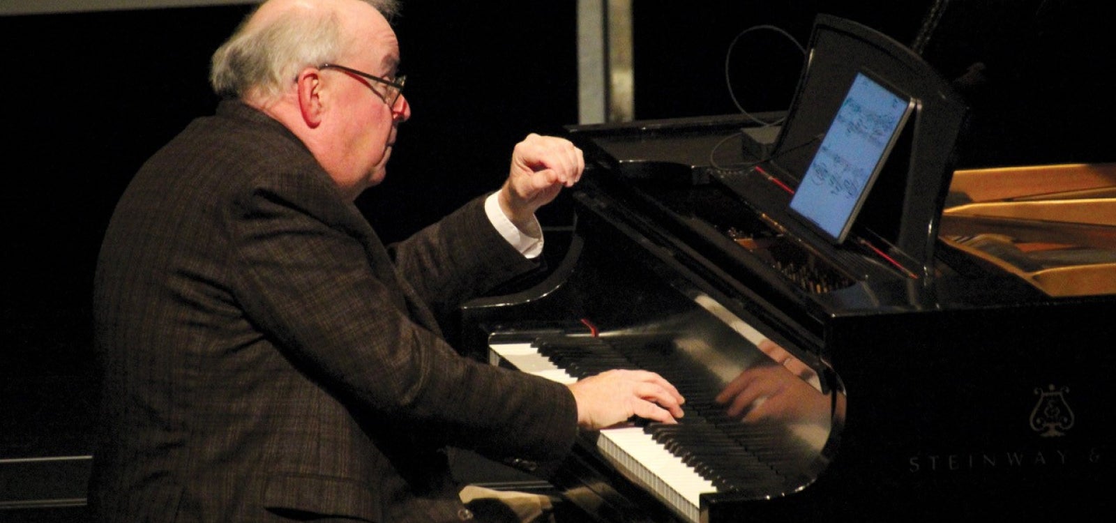 Pianist and music Professor Emeritus W. Terrence Spiller performs on the piano