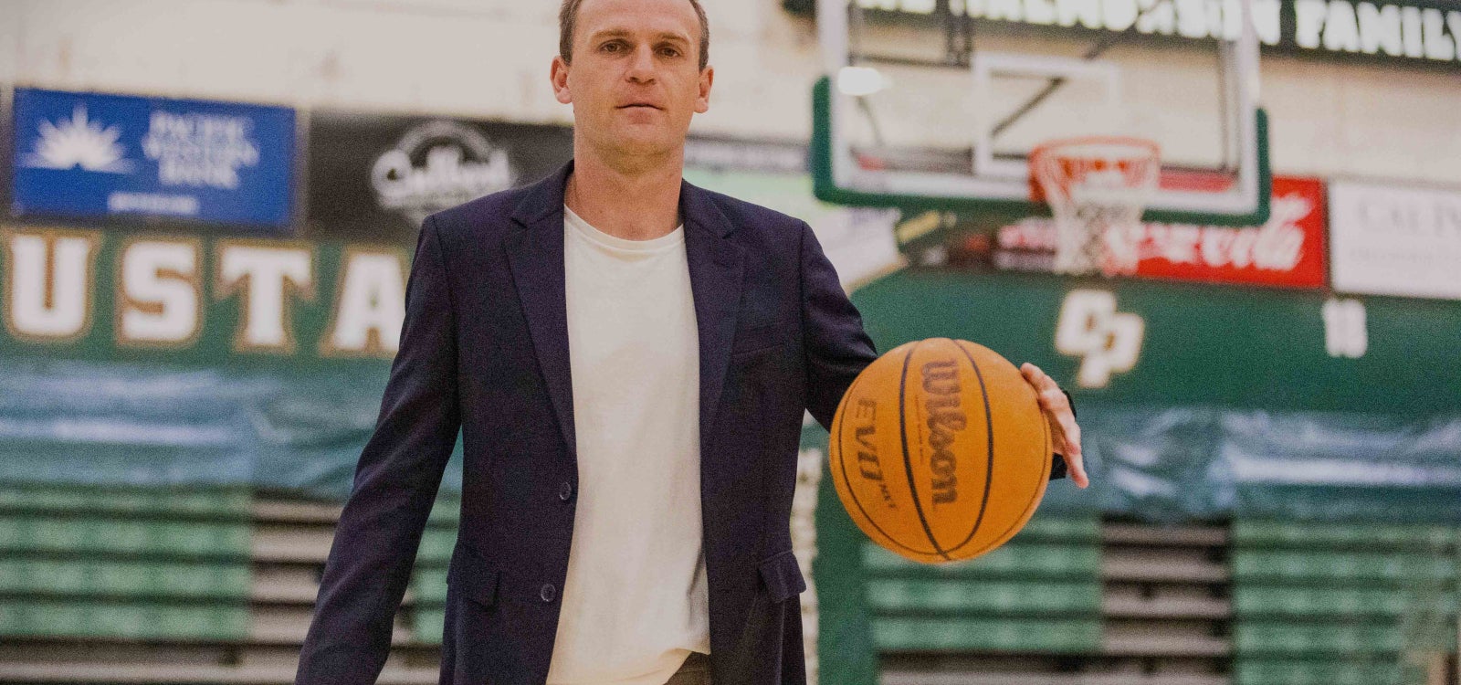 Associate Professor of economics Joseph Kuehn in Cal Poly’s Orfalea College of Business, holding a basketball, has been cited for his work analyzing what it takes to build a winning NBA team