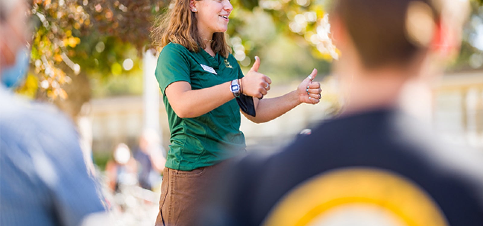 A Poly Rep student leader gives thumbs up during a campus tour