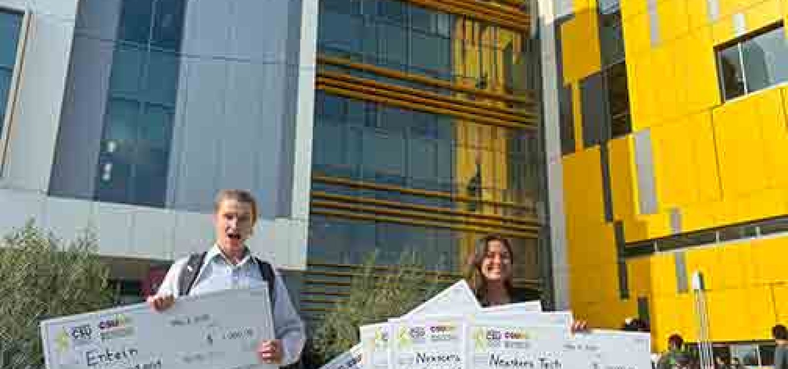 William Burns of the startup ENTEIN and Penny Lane Case of Nexstera Tech hold massive checks totalling $28000 at the CSU Startup Launch Competition