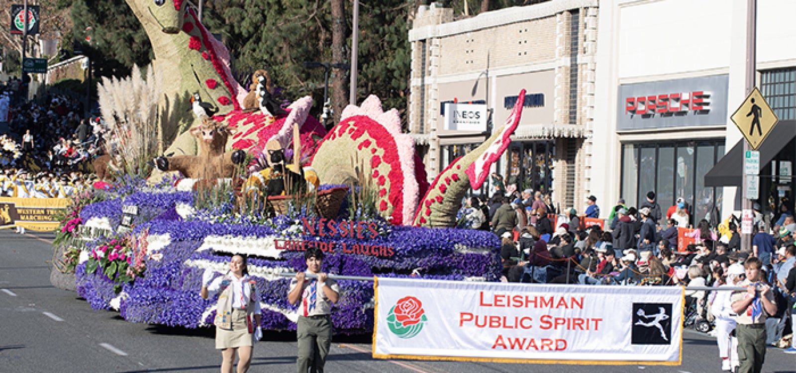 Scouts hold an award banner for Cal Poly Universities 2025 Rose Float entry Nessies Lakeside Laughs