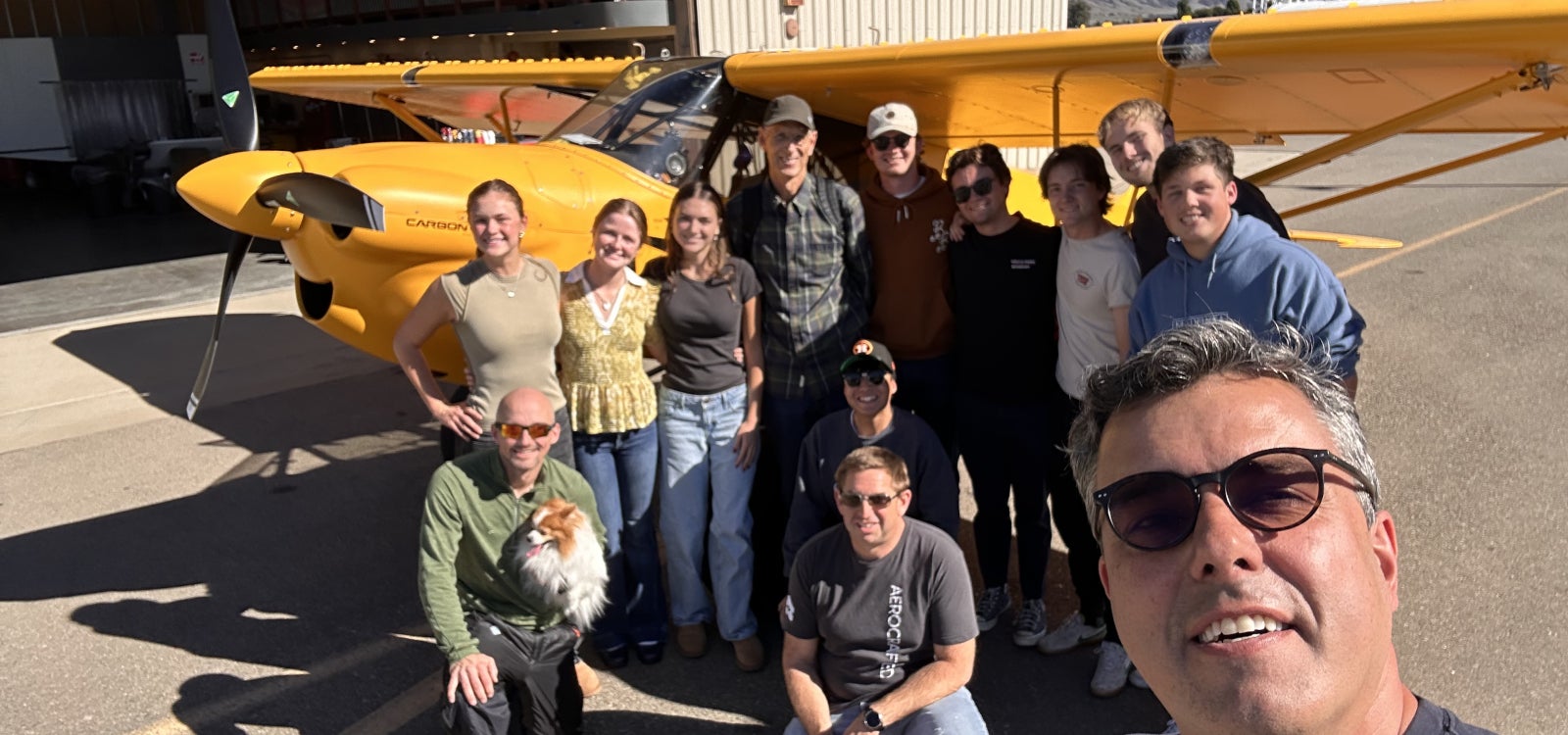 Cal Poly Professor Paulo Iscold with members of his flight test class and the record-setting yellow airplane at San Luis Obispo County Regional Airport
