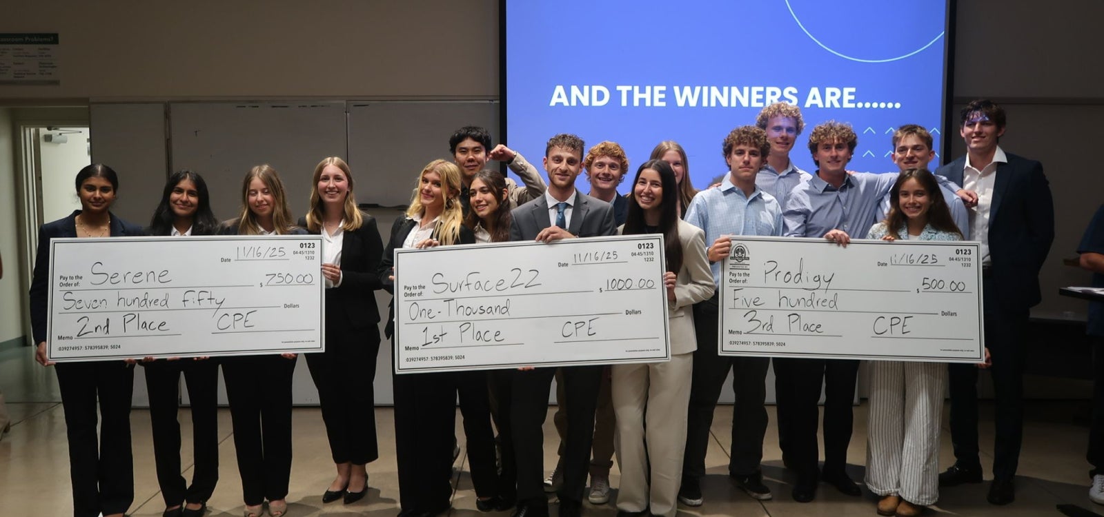 tartup Launch Weekend winners celebrate with their checks after pitching their startup concepts