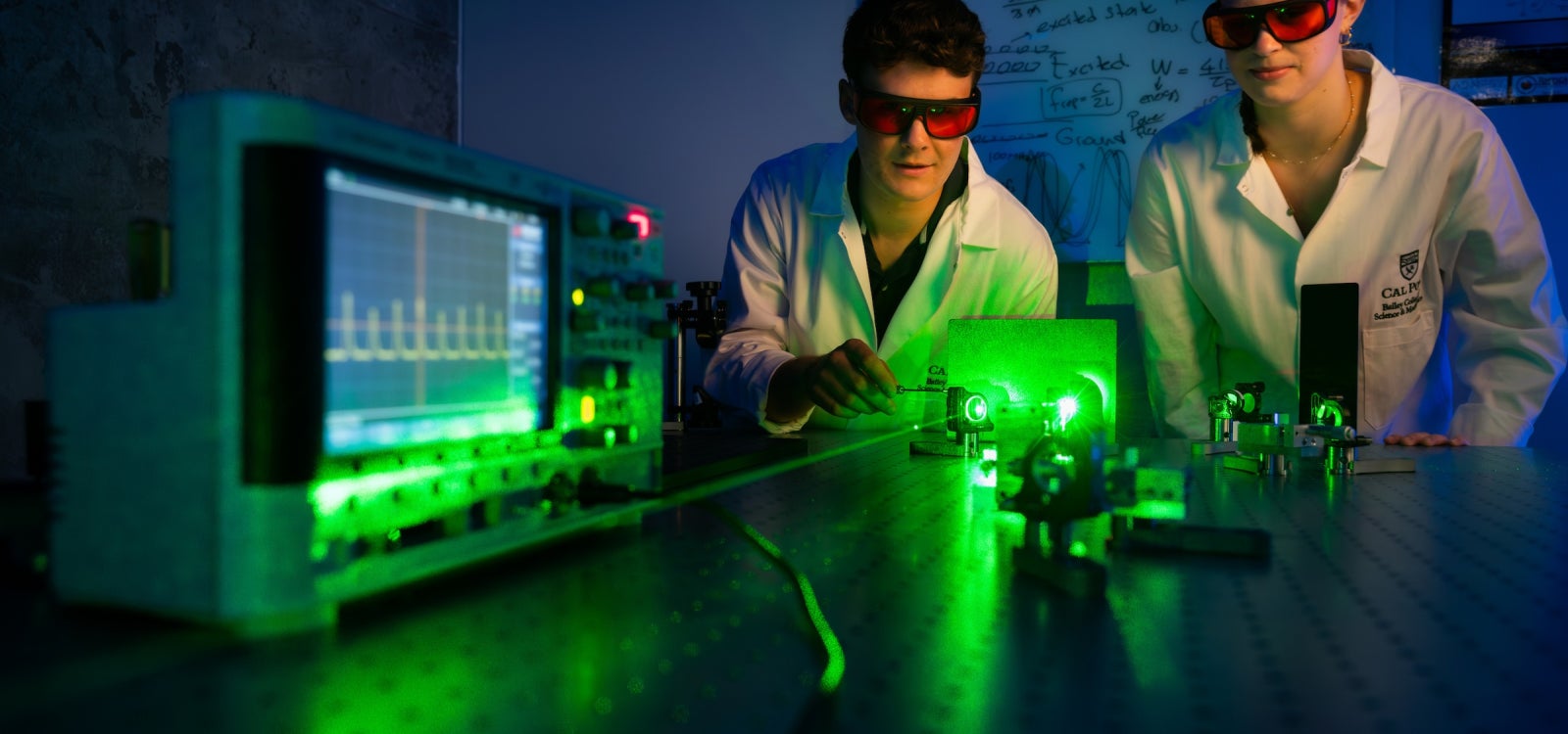 hysics students James Mauck and Hannah Bauer align a green light pump laser used as part of a project to build Cal Poly’s first laser