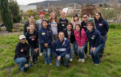 A group of College Corps members assemble for a photo