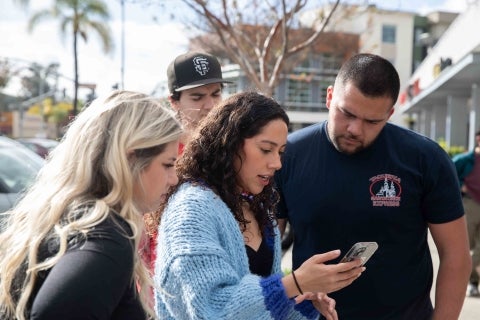 Long snapper Cruz Rubio on Cal Poly football team reviews video of himself promoting Taqueria Santa Cruz with his marketing team