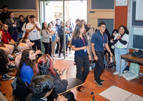 Cal Poly students Emily Prince and Adam Marin walk up to receive their award