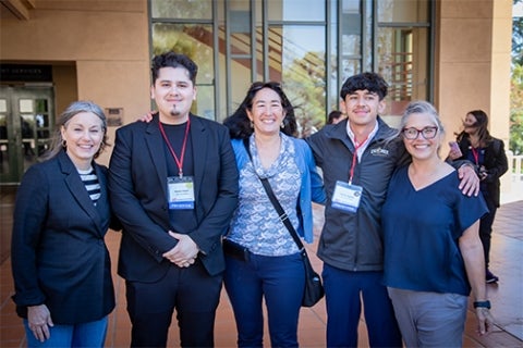 Cal Poly students Hector Reyes and Xavier Aguilar stand with three Cal Poly representatives 