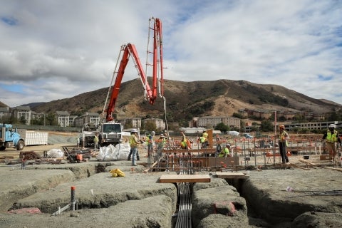 Workers pour concrete in foundation footings of the Charles and Claire Jacobson Animal Health Center 