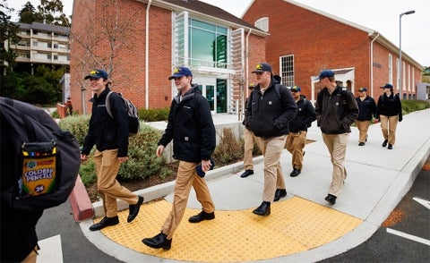 Cal Maritime Academy students walk past the bookstore and historic Mayo Hall