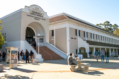Students walk past the entrance to the Cuesta College library