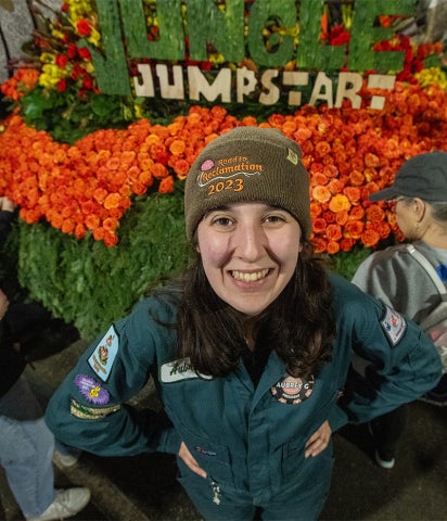 Cal Poly Rose Float President Aubrey Goings in front of Jungle Jumpstart during decoration