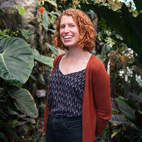 Ashley Grupenhoff standing in a Cal Poly greenhouse.