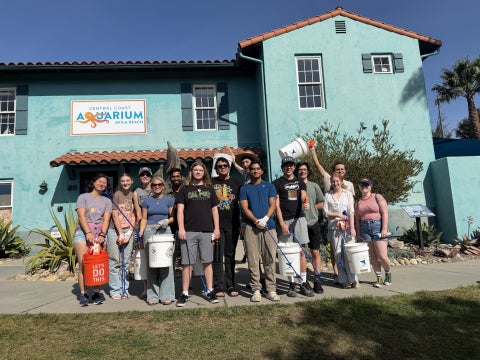 CAPED members pose outside the Central Coast Aquarium in Avila Beach during a beach cleanup