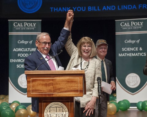 William and Linda Frost raise arms in announcing their transformational donation to Cal Poly in 2017