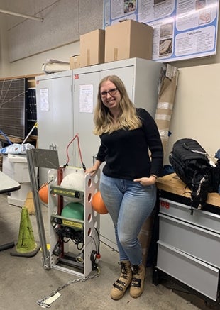 Nikki Arm standing next to her deep ocean vehicle lander.