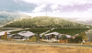 An architectural rendering showing two buildings near the Cal Poly radio tower on a hill near the Highland Drive entrance to campus