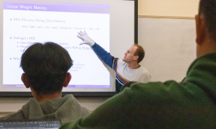 Professor Joseph Kuehn talks with students about using analytics in sports