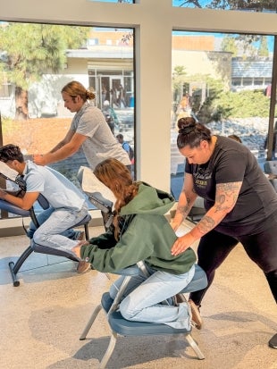 Massage therapists work on students during Campus Dinings' 2024 Self-Care Fair
