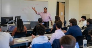 Finance Professor Cyrus Ramezani leads a class