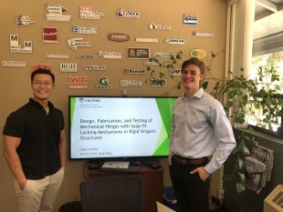 Structural engineering Professor Long Wang, left, and graduate student Colby Scanlon present their research on deployable structures