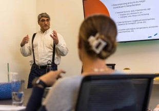 Hamed Ghoddusi presents research findings to a group of real estate professionals in San Luis Obispo during the summer of 2024.