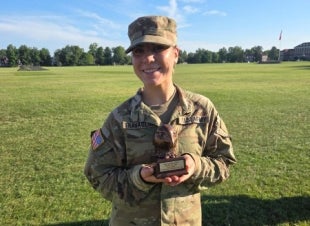 Cadet Gigi Travagline holding the Top Female Army Fitness Award