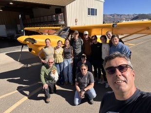 Cal Poly Professor Paulo Iscold with members of his flight test class and the record-setting yellow airplane at San Luis Obispo County Regional Airport