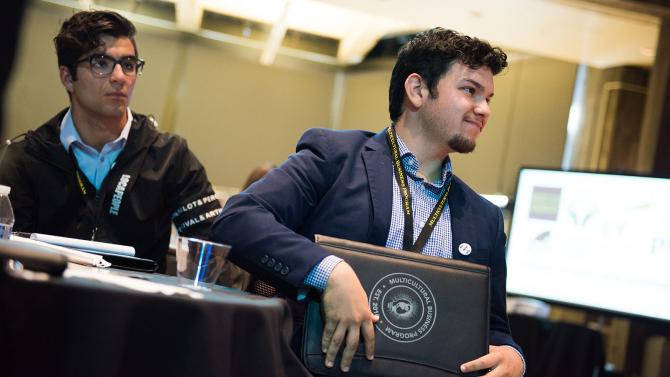 Student listens to a speaker at a conference