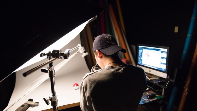 A photographer shoots an object in a studio.