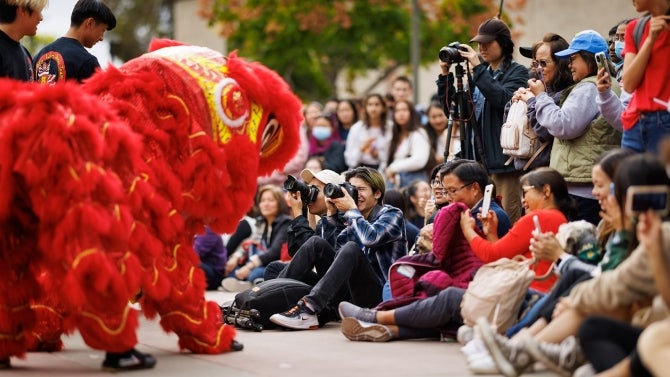 The audience, full of cameras, capture the dragon dance moments