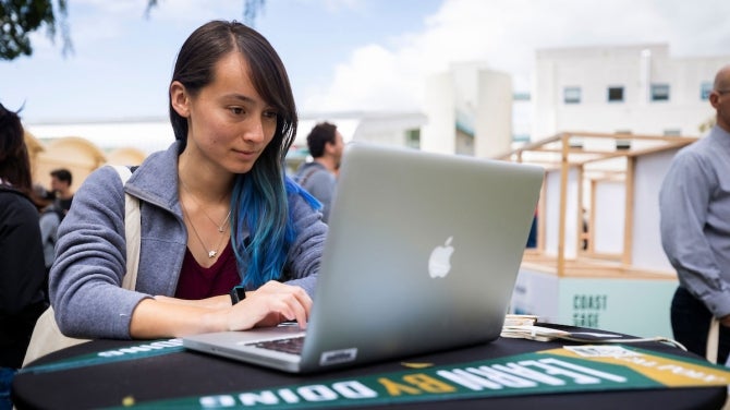 Woman outdoors working at a computer