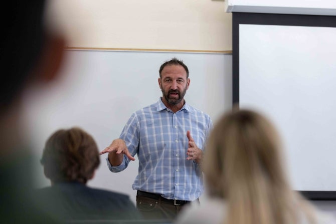 Randy Rovegno talks to students in his marketing projects class that he calls the Athlete Lab