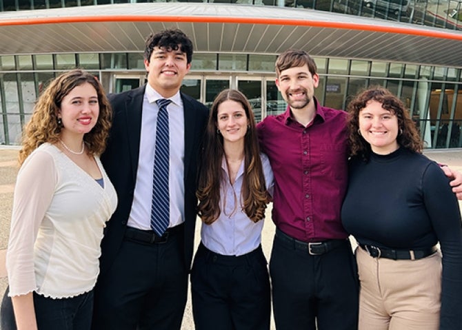 Five Cal Poly music students named soloists stand outside the Performing Arts Center